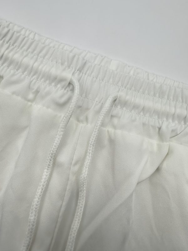 new products in 2025, a 2pcs set of summer simple men's short sleeved shirt and long pants. the white short sleeved shirt is paired with long pants in the same color system. the style is casual and elegant, suitable for daily outings.